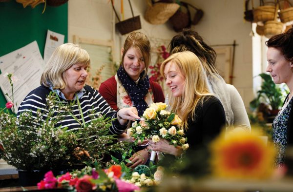 Floristry students receive a lecture on different types of plant from their tutor